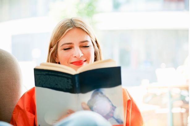 0 Smiling woman reading a book - How To Read English Books Effectively ?